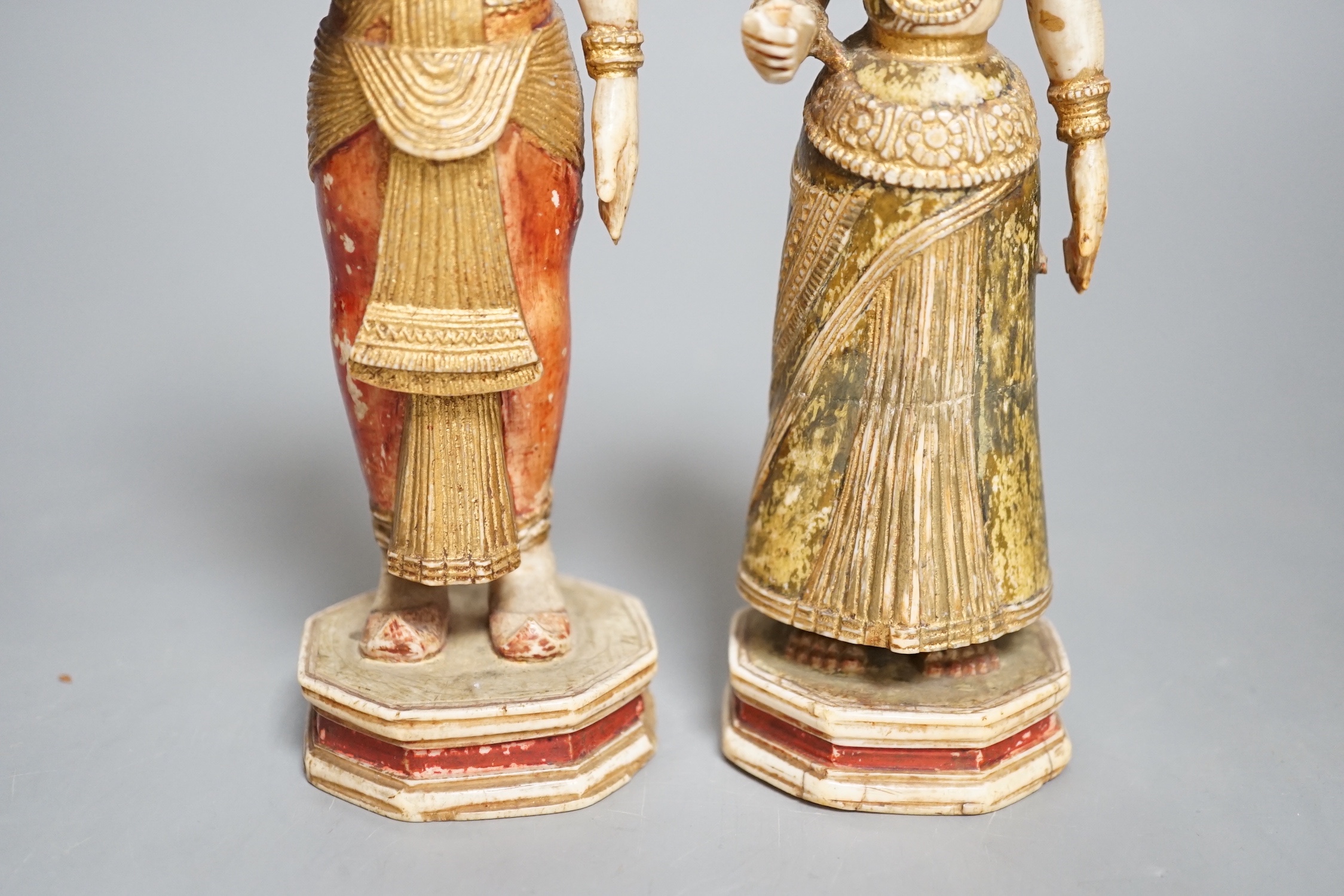 A pair of 18th century painted carved Indian ivory figures, male 7.6cm high female: 5.5cm high